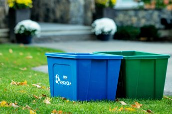 Busch Systems curbside recycling and organics containers outside history timeline