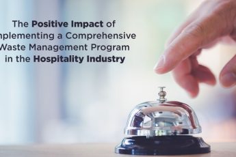 Person pressing a bell at a hotel desk